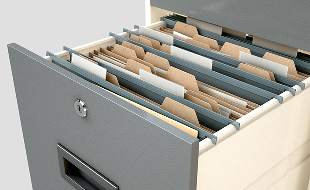 Open drawer in filing cabinet shows hanging manila folders