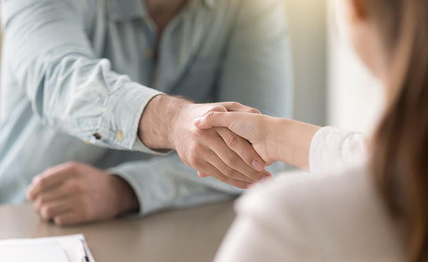 Business agreement handshake of man and woman at the office