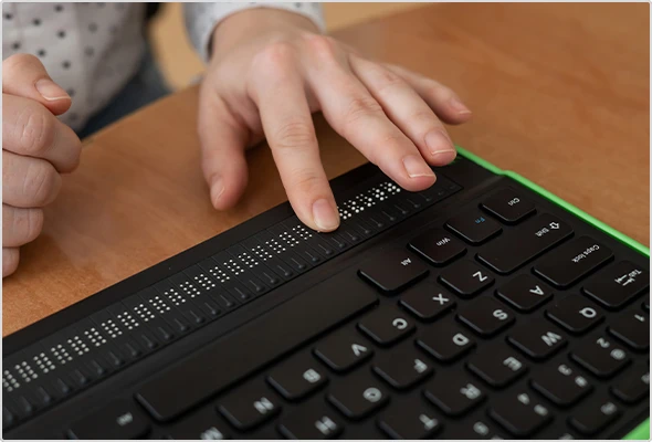 Hands using a Braille computer keyboard